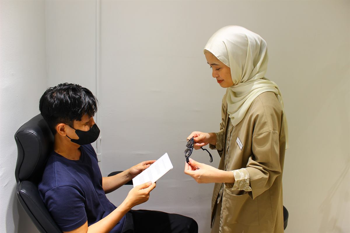 Optometrist explaining lens options during a clinic visit